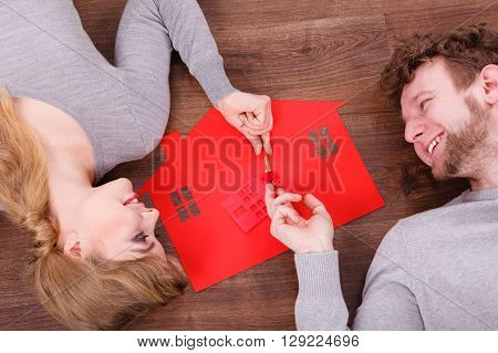 Young Couple Exchanging Keys.