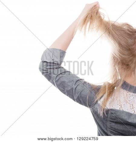 Fury and big anger inside of people. Blonde furious woman pulling blonde hair out of head. Emotional young girl showing her bad expression.