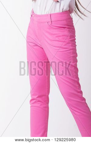 Close up pink women trousers in white background.