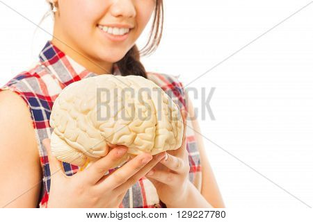 Smiling girl holding cerebrum model in her hands, isolated on white background