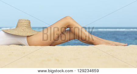 Close up image of girl's legs on the beach