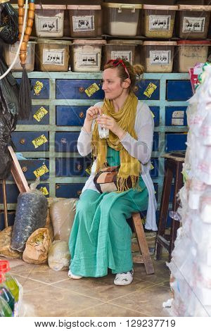 DARAW, EGYPT - FEBRUARY 6, 2016: Tourist having drink at Daraw market.