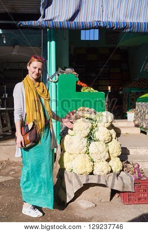 DARAW, EGYPT - FEBRUARY 6, 2016: Tourist standing by the vegetable stand at Daraw market.