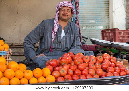 DARAW, EGYPT - FEBRUARY 6, 2016: Local food vendor at Daraw market selling oranges and tomatoes.