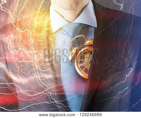 Concept of time with businessman in suit and clock
