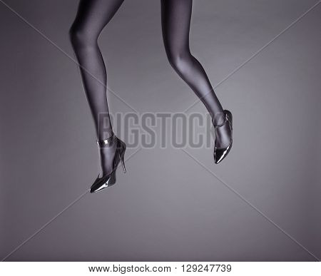 Woman's Legs Wearing Spandex Pantyhose and High Heels with space for text