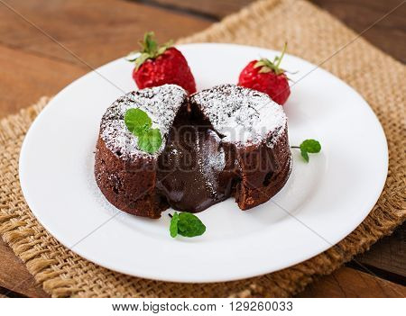 Chocolate Fondant (cupcake) With Strawberries And Powdered Sugar