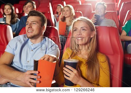 cinema, entertainment and people concept - happy friends watching movie in theater