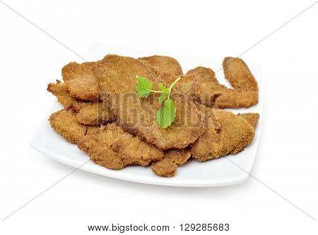 a plate with some cooked breaded fillets of seitan on a white background
