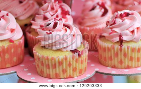 pink cake, decorated with berries on a tray
