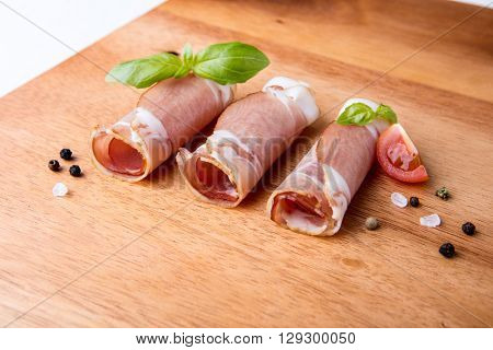 Black forest ham on wooden cutting board