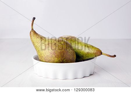 Two pears in porcelain dish