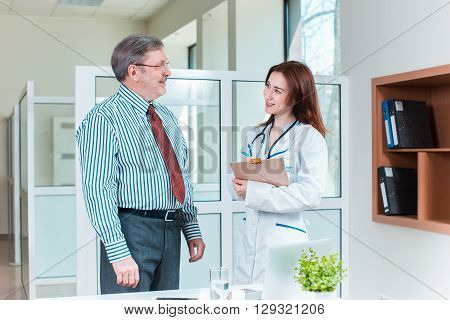 patient smiling to his doctor in medical office. Healthcare concept