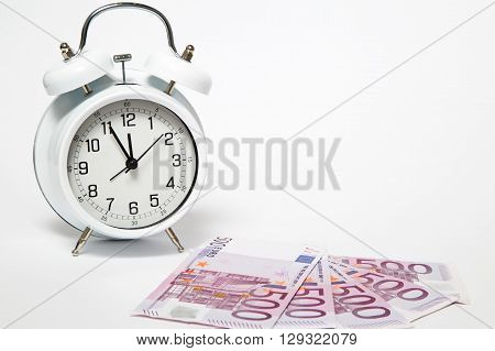 Old Clock and five hundred Euros, European bank withdraws five hundred banknotes.
