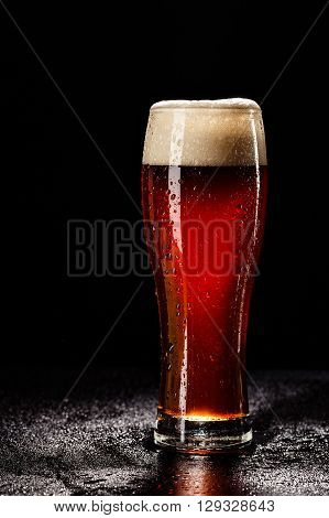 Beer Glass With Drops On Black. Fresh! Much Foam! Beer Bubbles Closeup. Draft. Overflow Beer Glass.