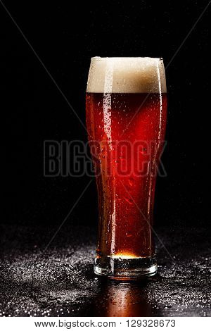 Beer Glass With Drops On Black. Fresh! Much Foam! Beer Bubbles Closeup. Draft. Overflow Beer Glass.