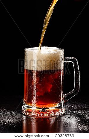 Process Filling Beer Glass With Drops On Black. Fresh! Much Foam! Beer Bubbles Closeup. Draft. Overf