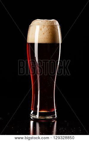 Beer Glass With Drops On Black. Fresh! Much Foam! Beer Bubbles Closeup. Draft. Overflow Beer Glass.