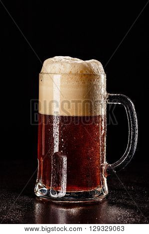 Beer Glass With Drops On Black. Fresh! Much Foam! Beer Bubbles Closeup. Draft. Overflow Beer Glass.