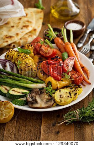 Grilled vegetables and chicken on wooden table overhead shot