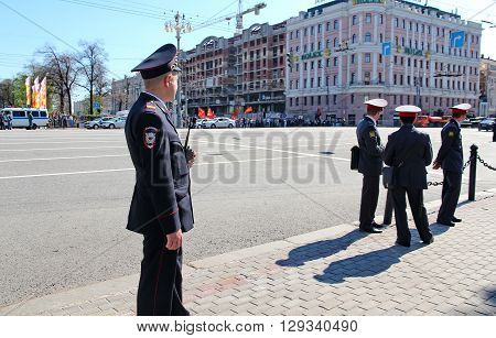 MOSCOW RUSSIAN - MAY 9 2013: Policemen in cordon wait for motorcade on TverskayaStreet on parade devoted to devoted to Victory Day. For editorial use only.