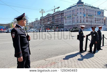MOSCOW RUSSIAN - MAY 9 2013: Policemen in cordon wait for motorcade on TverskayaStreet on parade devoted to devoted to Victory Day. For editorial use only.