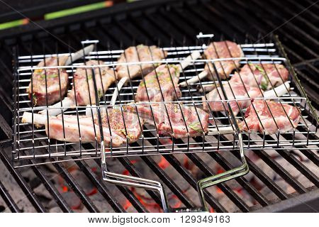 Lamb chops in grilling basket cooking on grill