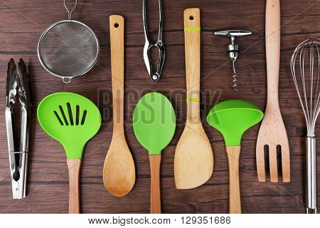 Set of stainless and wooden utensils on wooden background