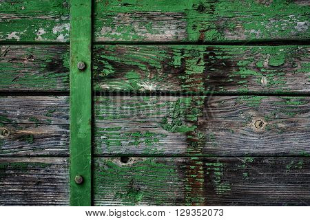 old board with peeling off paint metal lath and bots