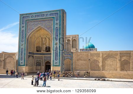 Buckara Uzbekistan - Aprilr 16 2014: Local people in front of the Kalon mosque