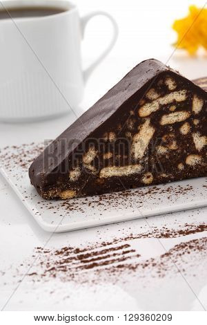 Chocolate cake white coffee cup fork shape orange flowers close up table top shot