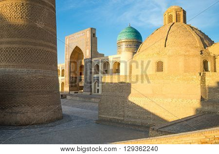 Buckara Uzbekistan - Aprilr 16 2014: The Kalon minaret and the Mir-i-Arab madrassah in the background