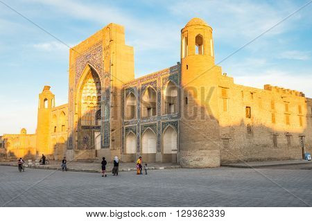 Buckara Uzbekistan - Aprilr 16 2014: Local people in the squatr of the Isa Ayub old mosque