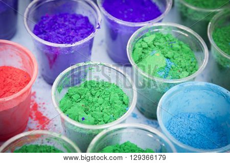 NEW YORK - APR 30 2016: The colorful powder in cups used to celebrate Holi Hai at the Festival of Colors celebration in Dag Hammerskjold Plaza hosted by NYC Bhangra in New York on April 30, 2016.
