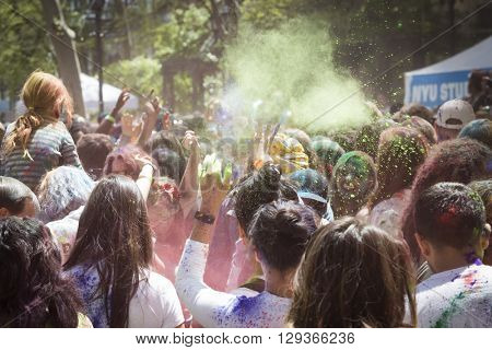 NEW YORK - APR 30 2016: People celebrating Holi Hai Festival of Colors with colorful powder on their faces in Dag Hammerskjold Plaza hosted by NYC Bhangra in New York on April 30, 2016.
