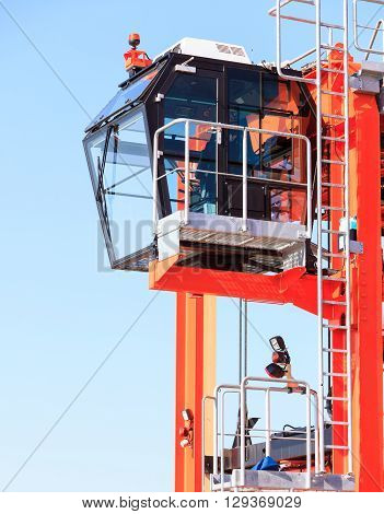 Cockpit of modern crane industry detail. Blue sky background