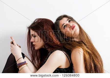 One Girl On The Smartphone And The Other One Wanting To Talk To Her Frustrated