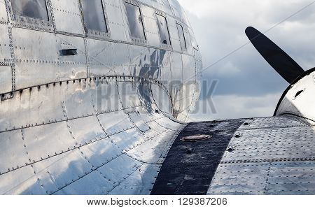 square windows of the old airplane sunny day reflection of the sky in aluminum casing