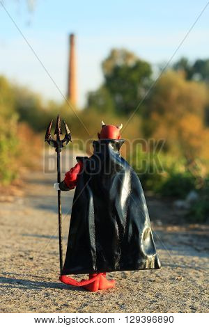 Doll of Devil with forks on the road