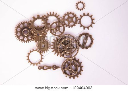 Metal clock gears and hand clock on the white background