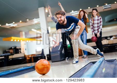 Friends having fun while bowling and speding time together