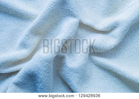 Closeup surface wrinkled blue napkin fabric background