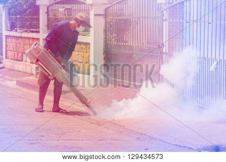 Blurred focus officer is spraying chemical for anti an outbreak of dengue fever