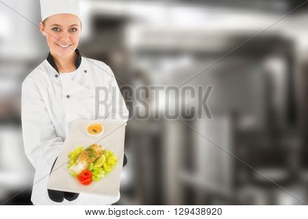 Female chef offering healthy food against pots standing on hotplate