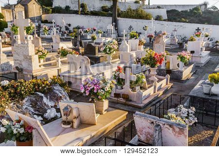 Crato, Portugal. December 12, 2015: Typical Catholic cemetery with the graves decorated with flowers in the interior south of Portugal.