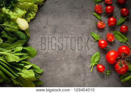 Green and red vegetables at slate background with space for text. Healthy eating and Diet concept. Vegan food background.