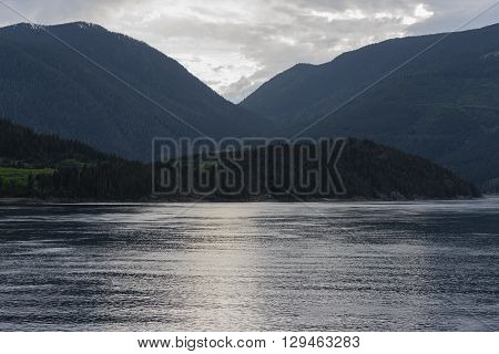 The Inside Passage with calm waters and green mountains in the background
