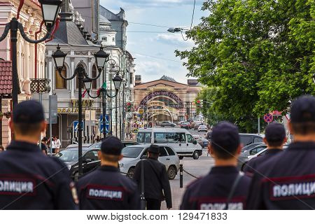 The photo shows the back of police patrolling the streets of Kazan the building of the central market theater advertising signs cars and city residents. The photo was taken in Kazan in the street Bauman June 11 2015.