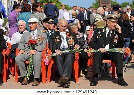 Orel Russia - May 9 2016: Celebration of 71th anniversary of the Victory Day (WWII). Russian war veterans sitting in bright sun horizontal