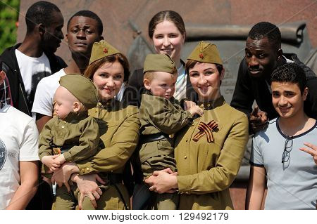 Orel Russia - May 9 2016: Celebration of 71th anniversary of the Victory Day (WWII). Russian women and children in military uniform with African and Indian men horizontal
